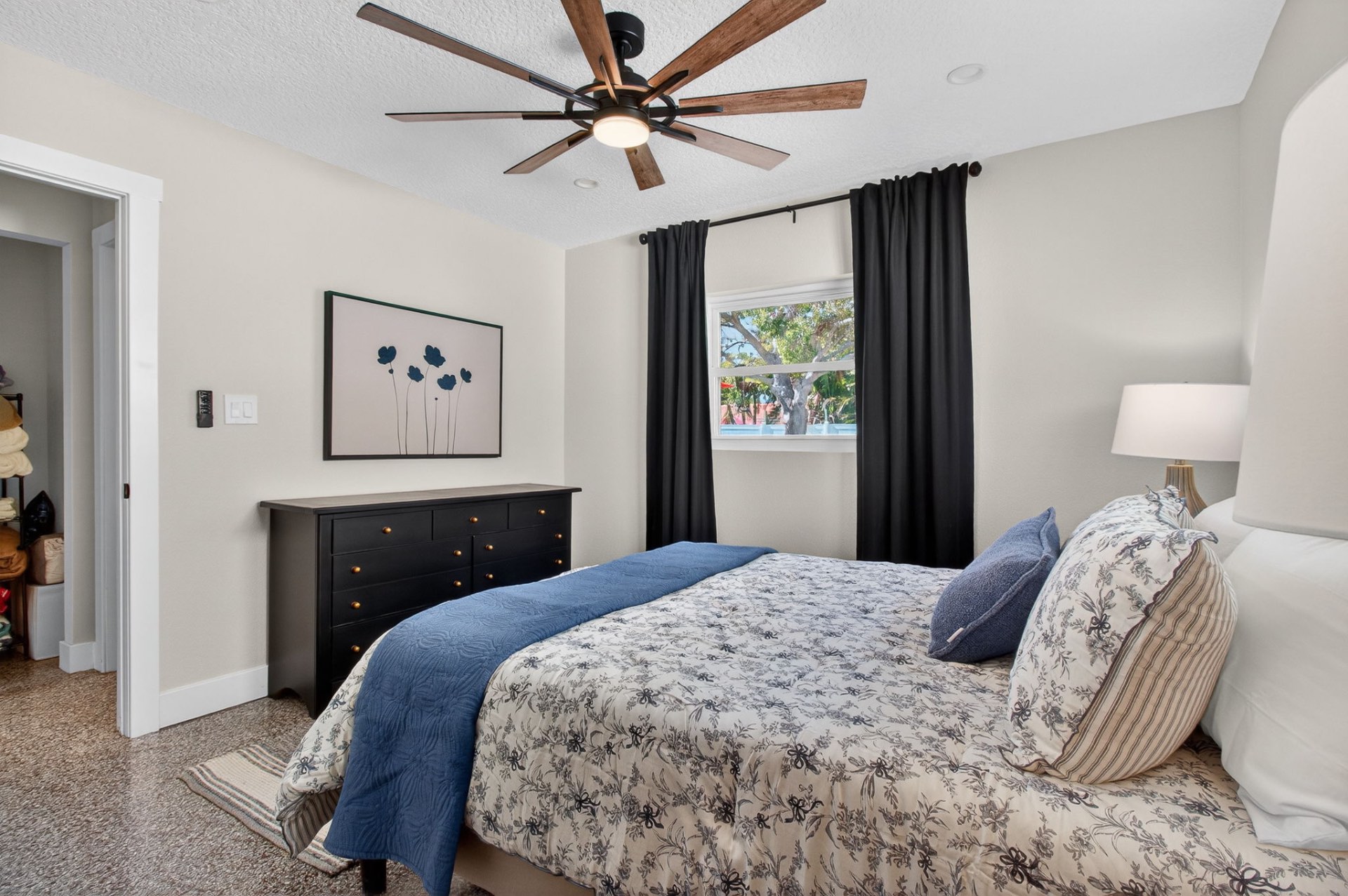 Guest bedroom with blackout drapery and floral bedding