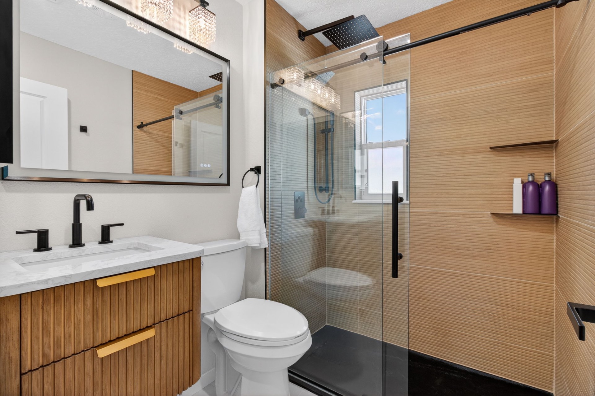 Spa-style bath with rainfall shower and warm wood tile