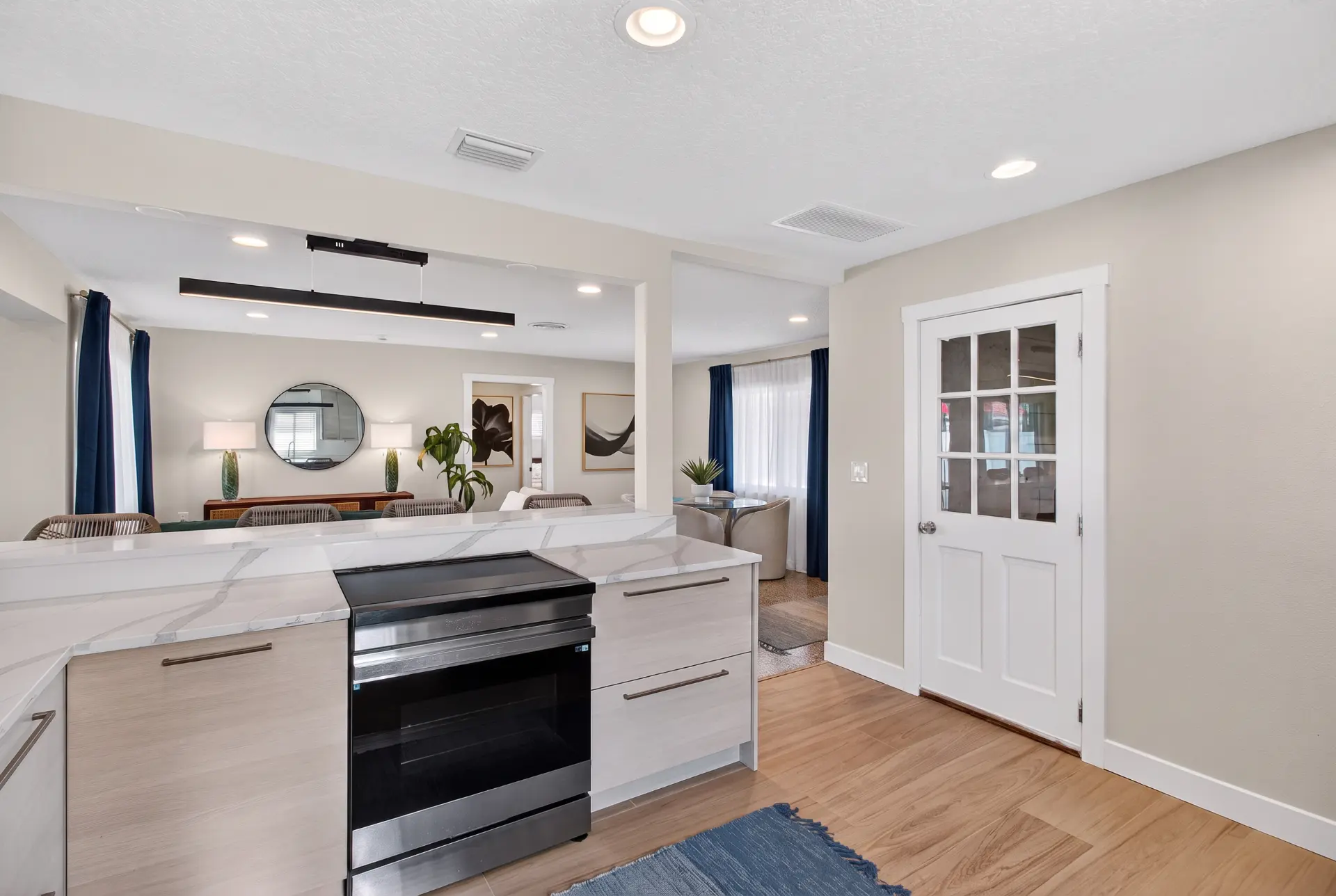 Induction range and marble waterfall island in the renovated kitchen