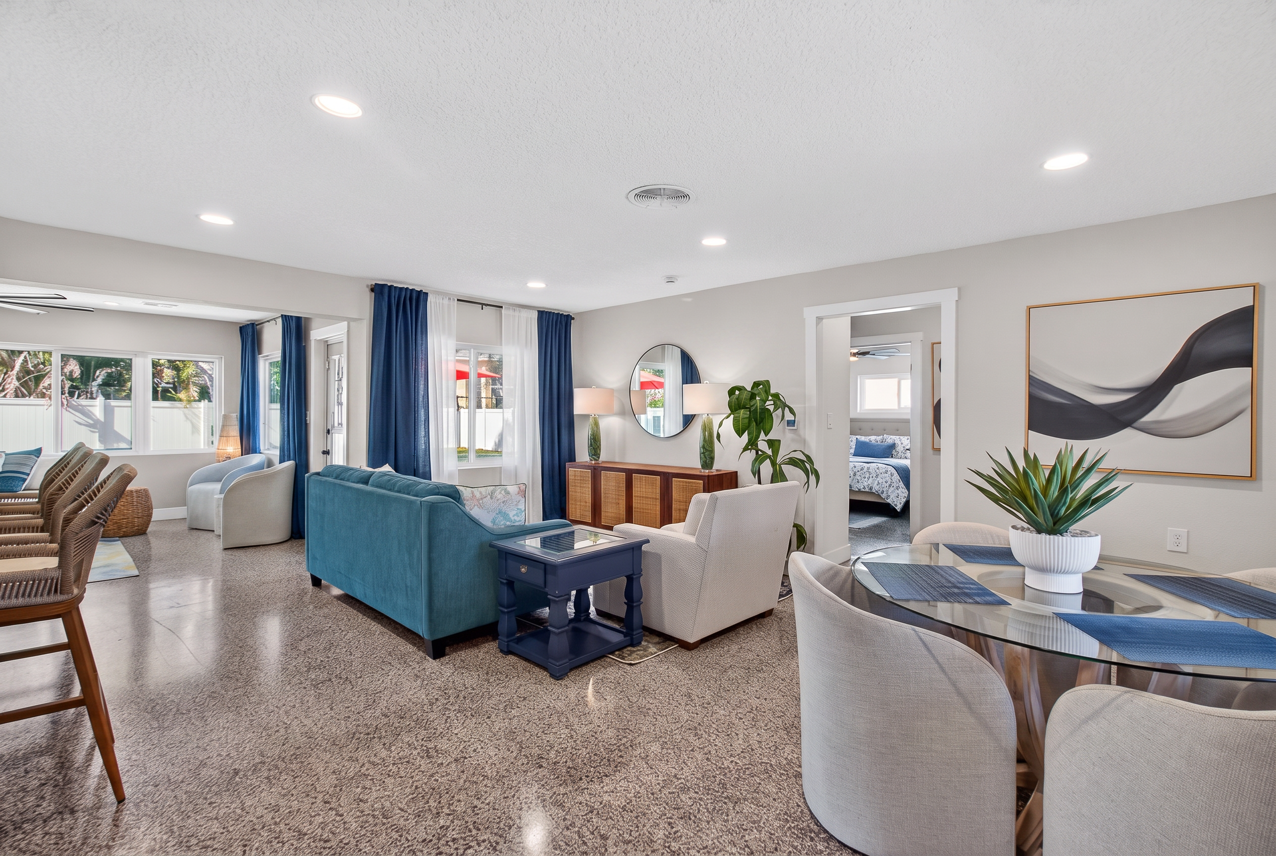 Open-plan living and dining room with terrazzo floors and warm neutrals
